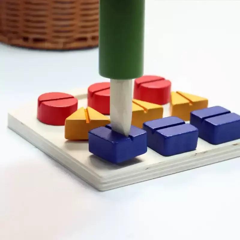 Wooden screwdriver turning a blue square screw on the board