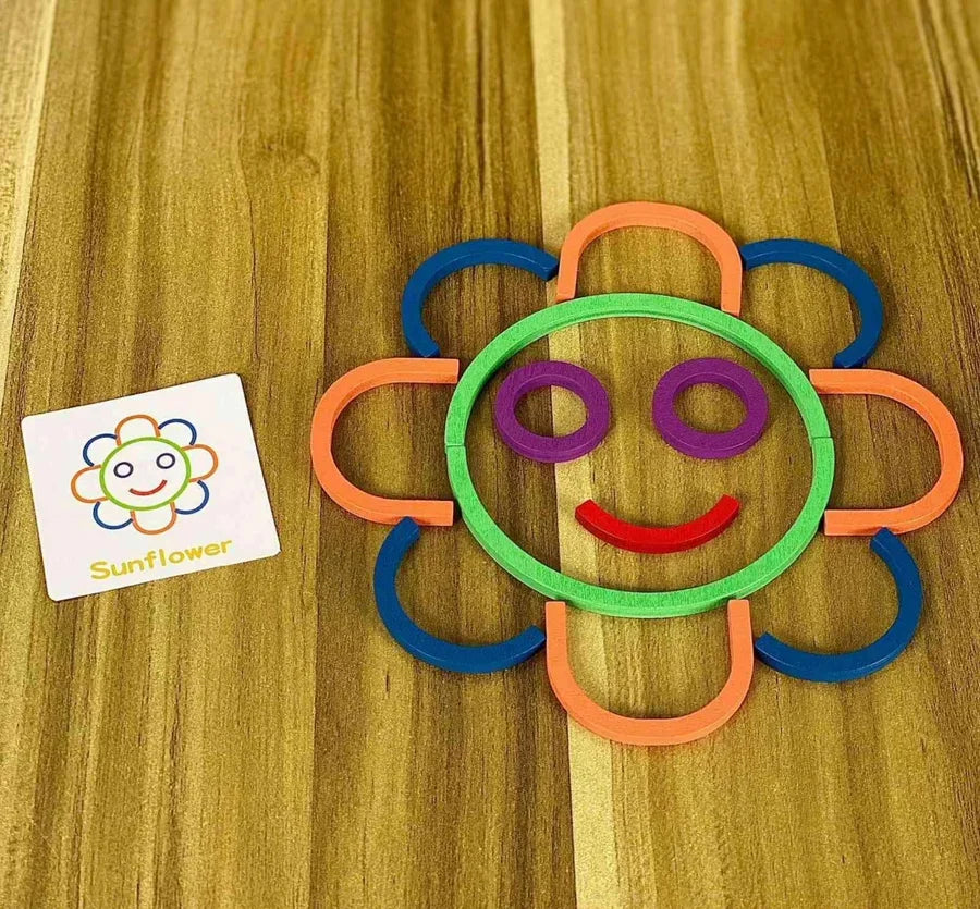 A flower made from sticks and rings, next to its shape card.