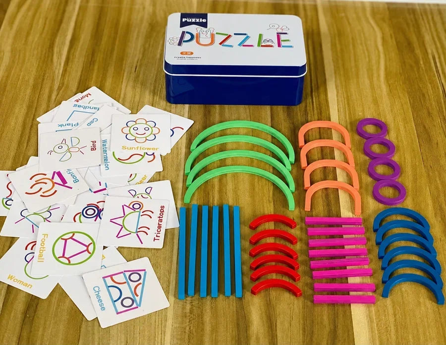 Coloured wooden pieces, shape cards and a metal case laid out on a table.