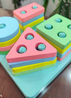 Close view of pastel wooden shapes on pegs