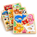 Stack of wooden finger-grip puzzles: sea animals, safari animals, and vehicles